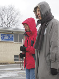 Barb Yagely and Joan Cooney, parishioners at St. Anastasia in Troy and St. Hugo of the Hills in Bloomfield Hills, respectively, pray in front of Woman Care abortion clinic. 